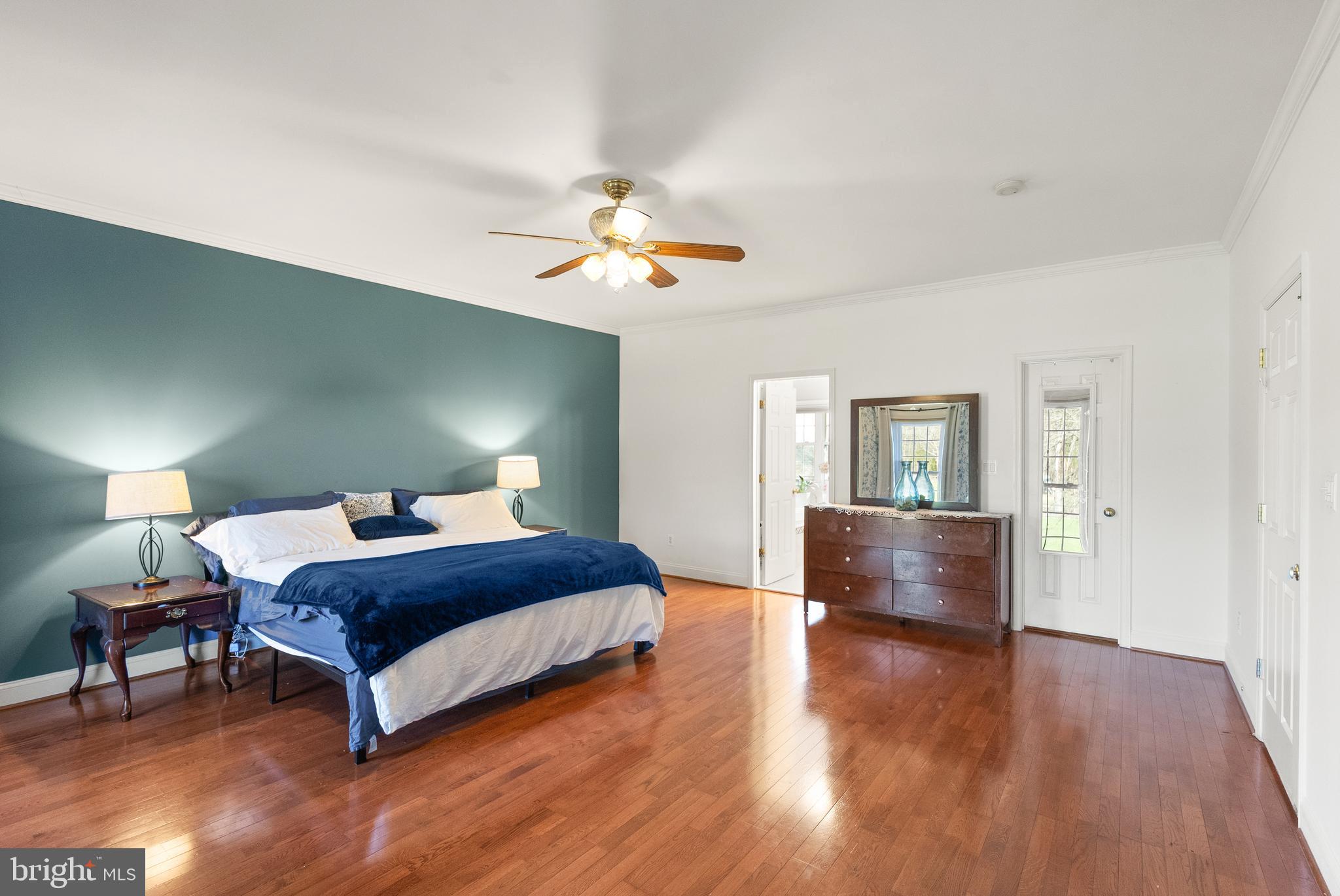 13145 Carriage Ford Road Nokesville, VA 20181 - Photo 21 of 70 a bedroom with a bed chandelier and a window