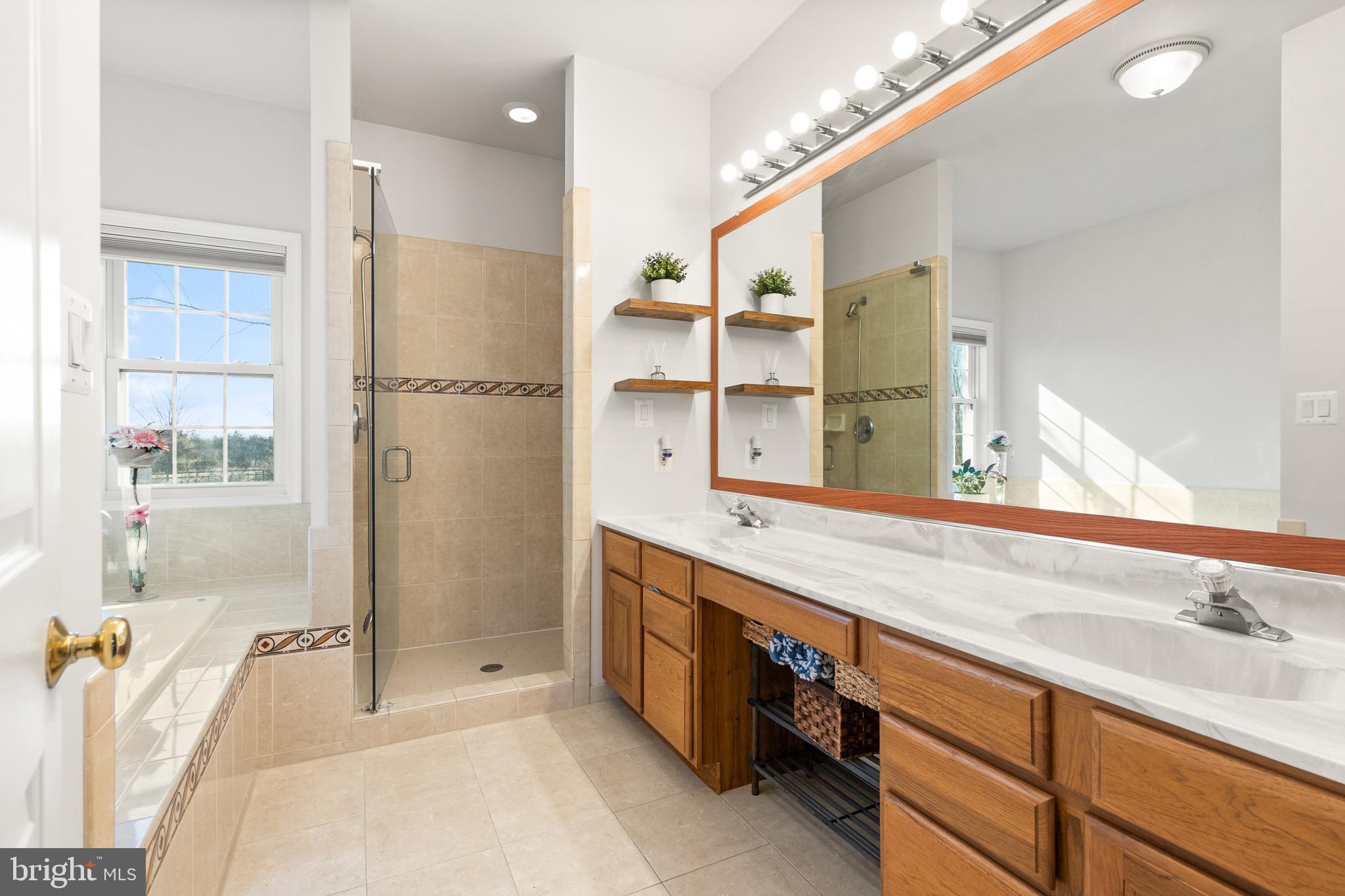 13145 Carriage Ford Road Nokesville, VA 20181 - Photo 22 of 70 a spacious bathroom with a double vanity sink a mirror and a shower