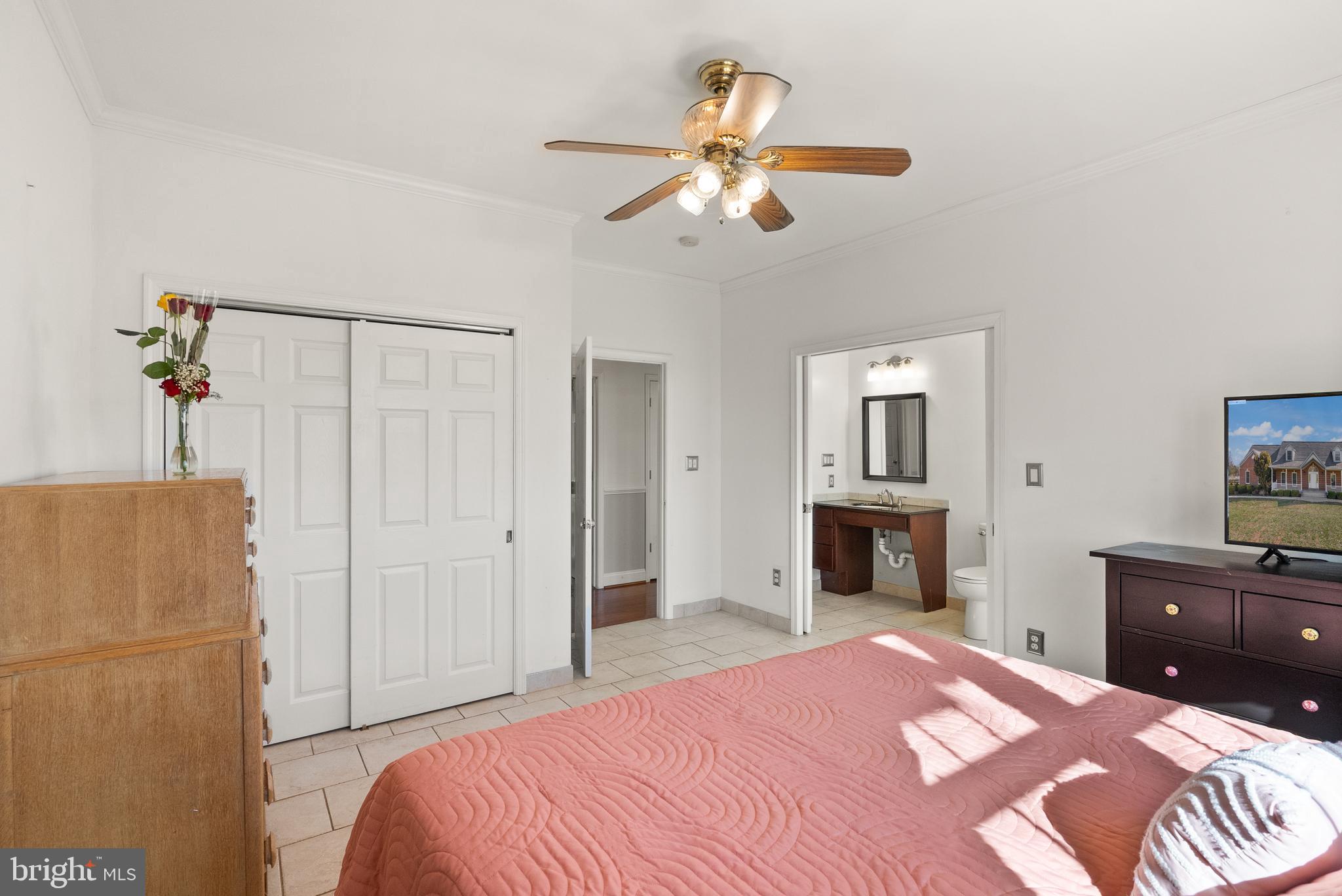 13145 Carriage Ford Road Nokesville, VA 20181 - Photo 26 of 70 a bedroom with a bed and a chandelier