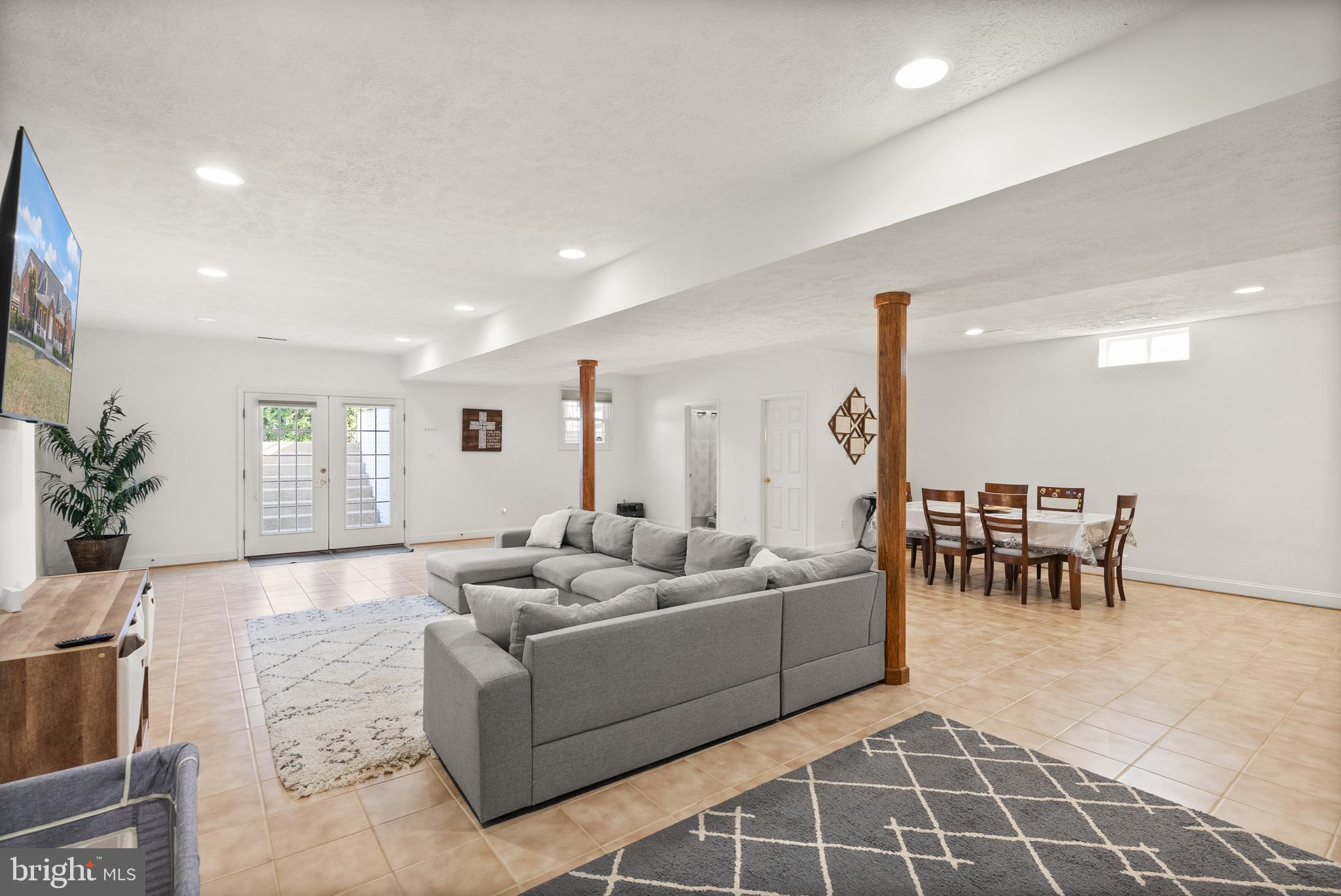 13145 Carriage Ford Road Nokesville, VA 20181 - Photo 46 of 70 a living room with furniture and a dining table with wooden floor