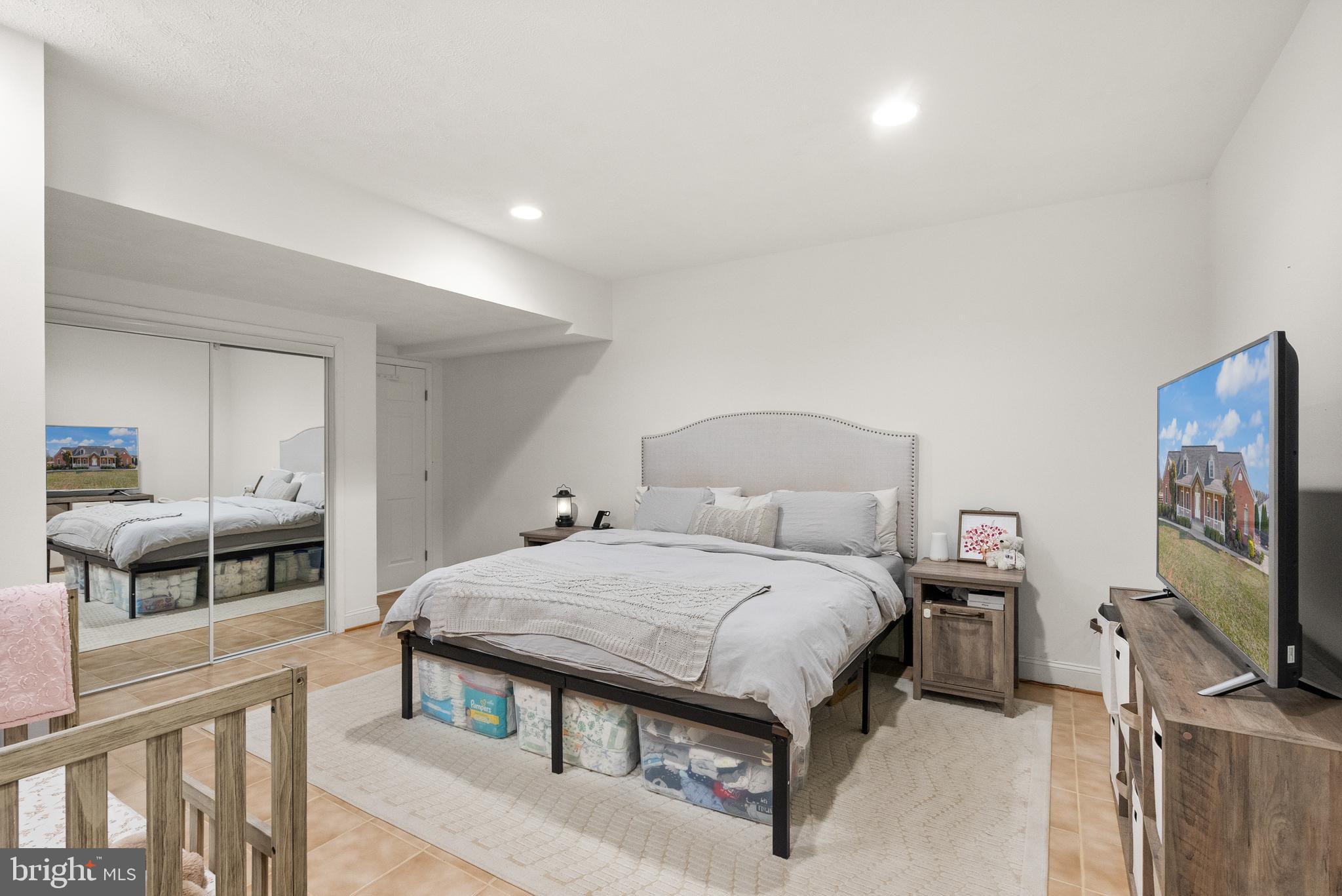 13145 Carriage Ford Road Nokesville, VA 20181 - Photo 53 of 70 a bedroom with a bed and a flat screen tv