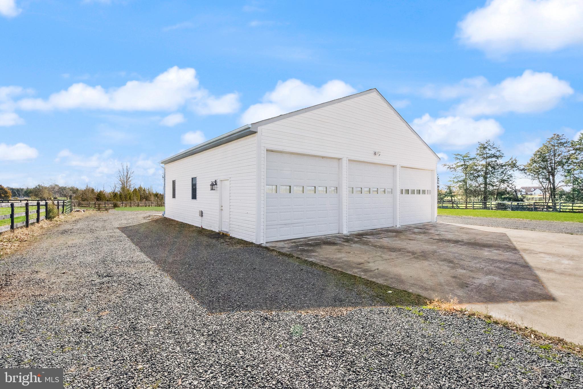 13145 Carriage Ford Road Nokesville, VA 20181 - Photo 62 of 70 a view of a white house with a yard and garage
