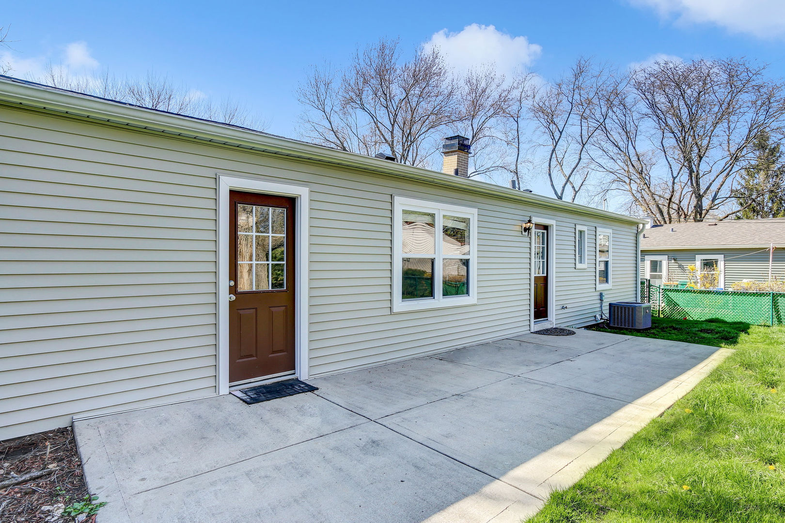 273 Raupp Boulevard Buffalo Grove, IL 60089 - Photo 16 of 18 a view of a house with a yard and potted plants