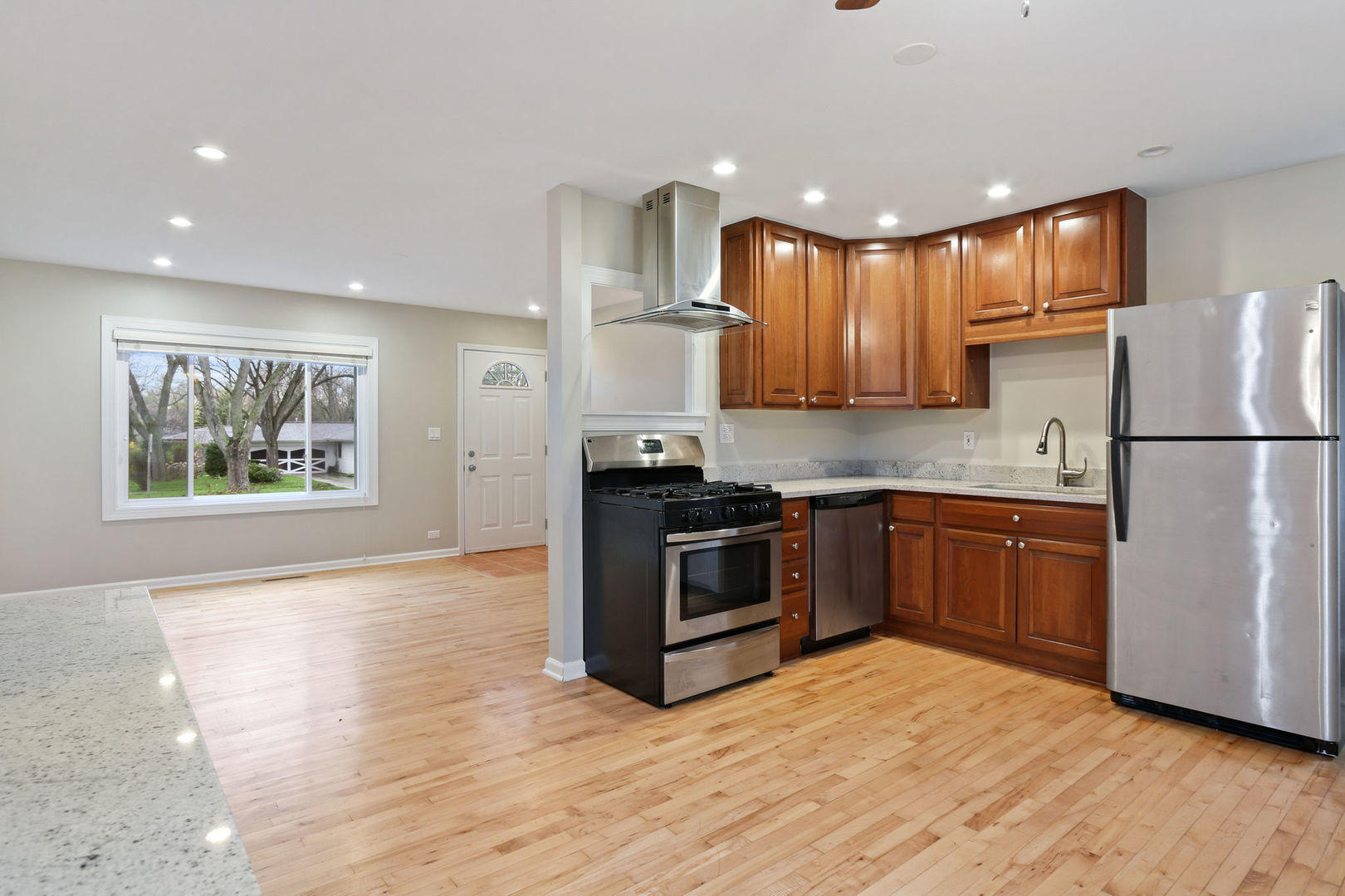 273 Raupp Boulevard Buffalo Grove, IL 60089 - Photo 4 of 18 a kitchen with a refrigerator and a stove top oven