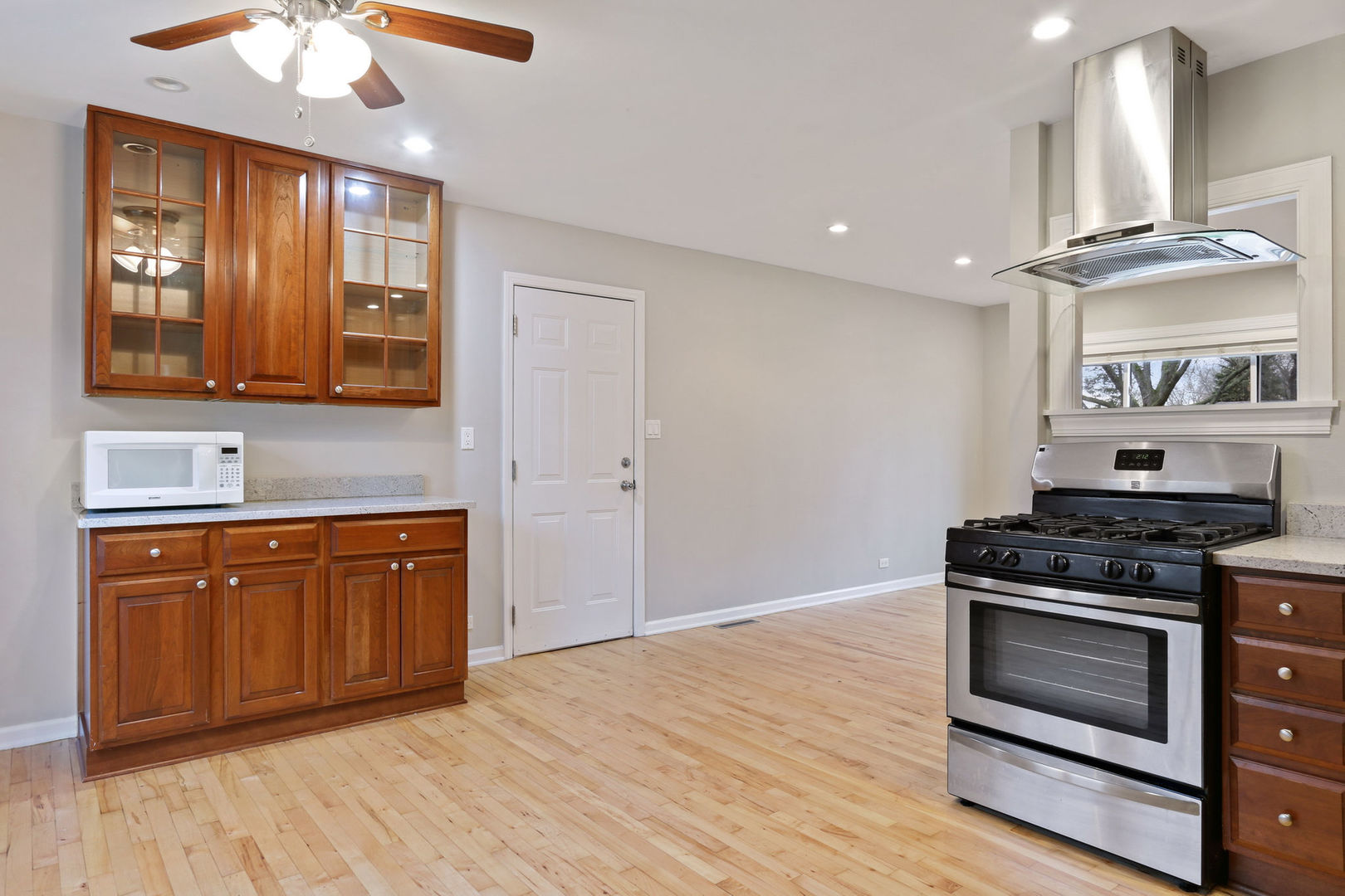 273 Raupp Boulevard Buffalo Grove, IL 60089 - Photo 5 of 18 a kitchen with stainless steel appliances granite countertop a stove and a sink