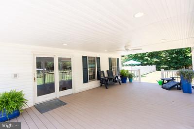 23130 Sparks Road Ridgely, MD 21660 - Photo 9 of 18 Inviting porch with lush greenery.