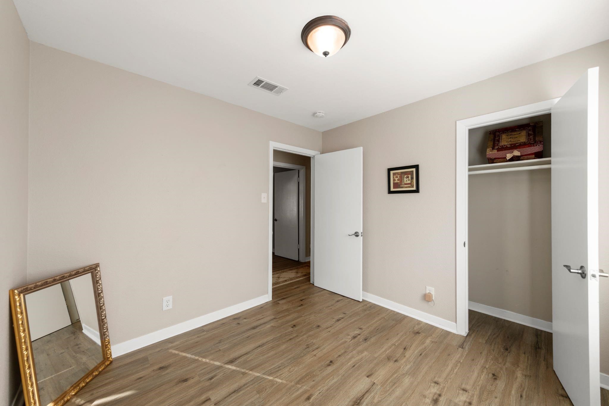 10128 Homestead Road Houston, TX 77016 - Photo 5 of 9 a view of an empty room with wooden floor