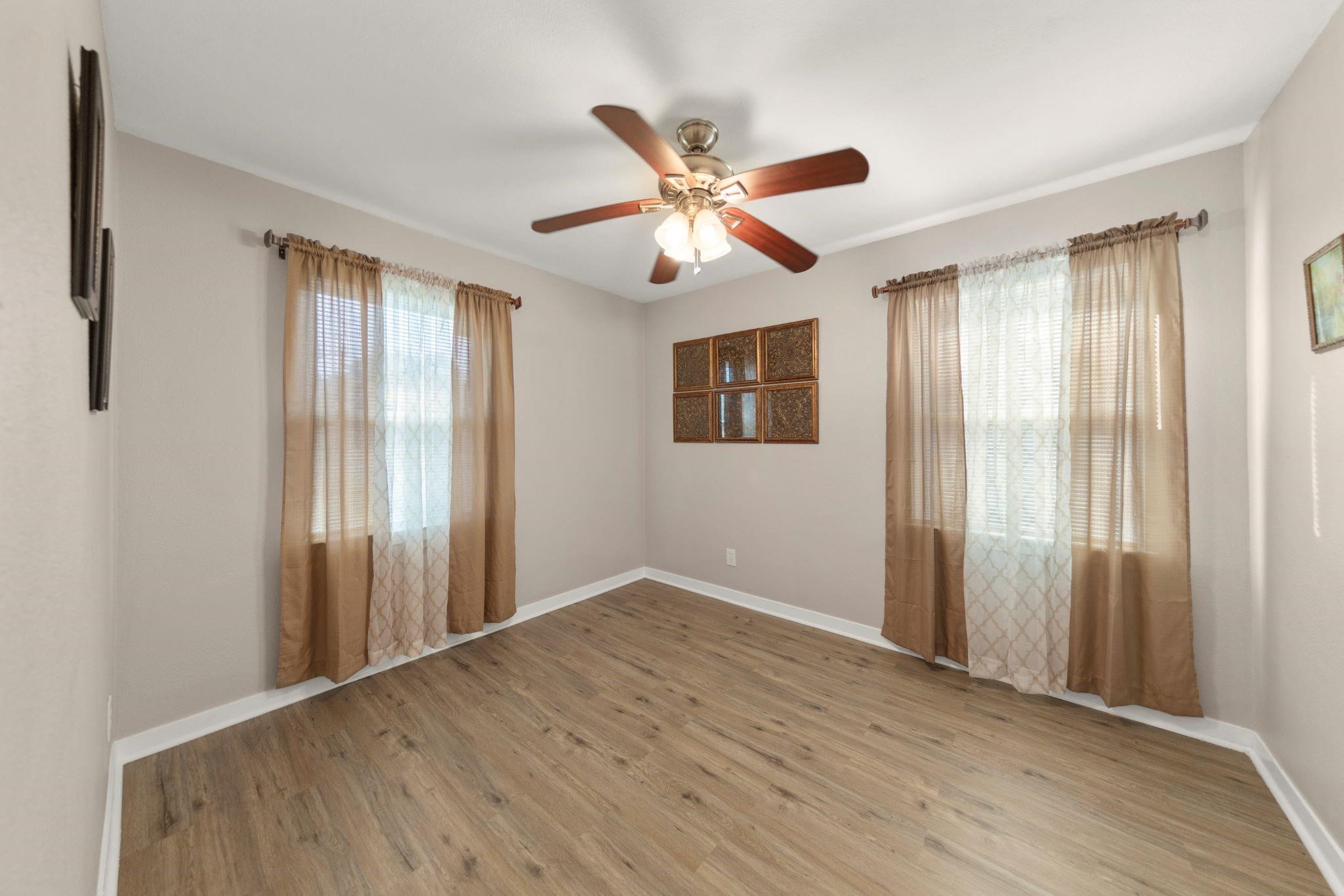 10128 Homestead Road Houston, TX 77016 - Photo 6 of 9 a view of empty room with wooden floor and fan