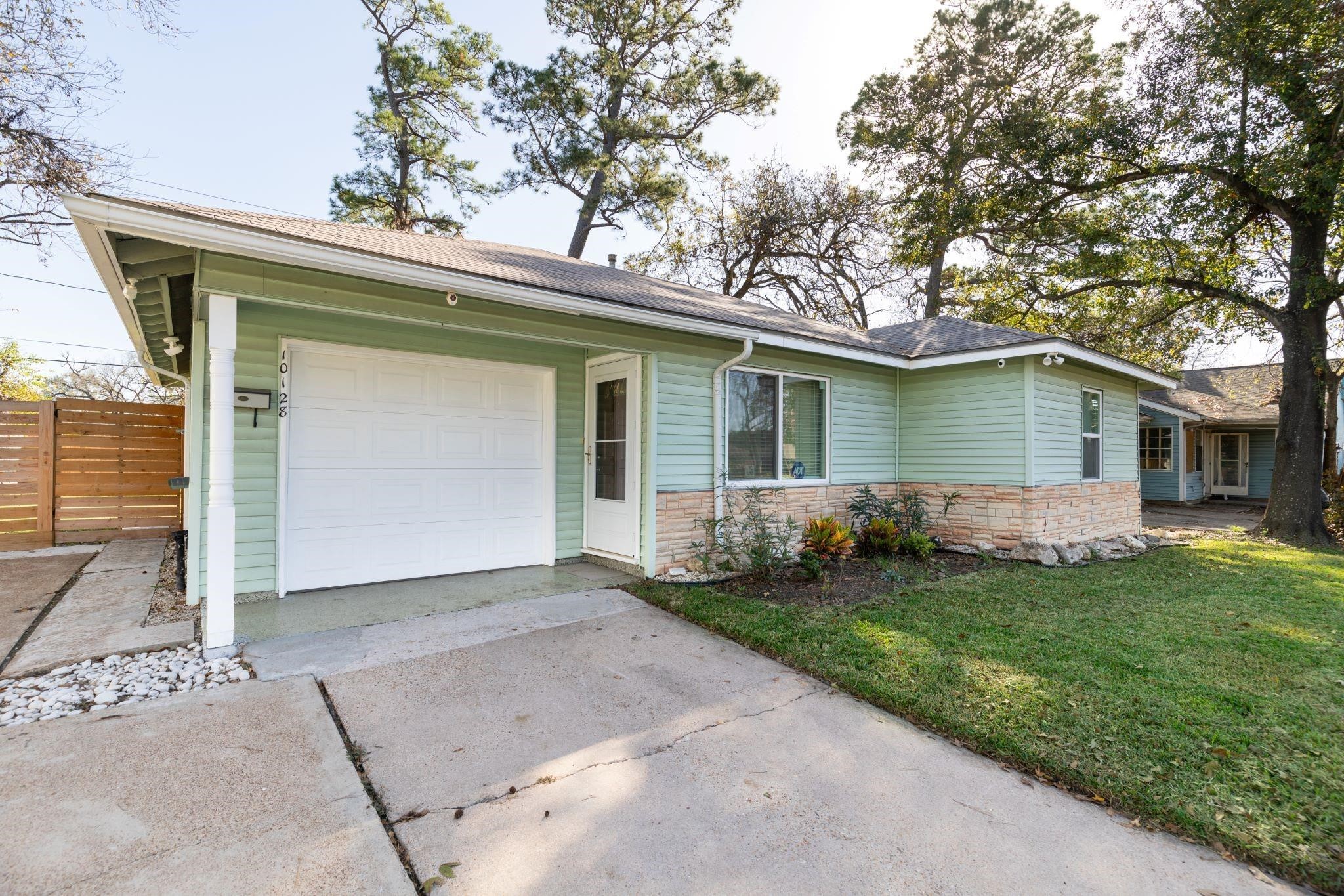 10128 Homestead Road Houston, TX 77016 - Photo 9 of 9 a front view of a house with a garden