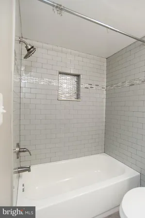 a bathroom with a shower and a bathtub