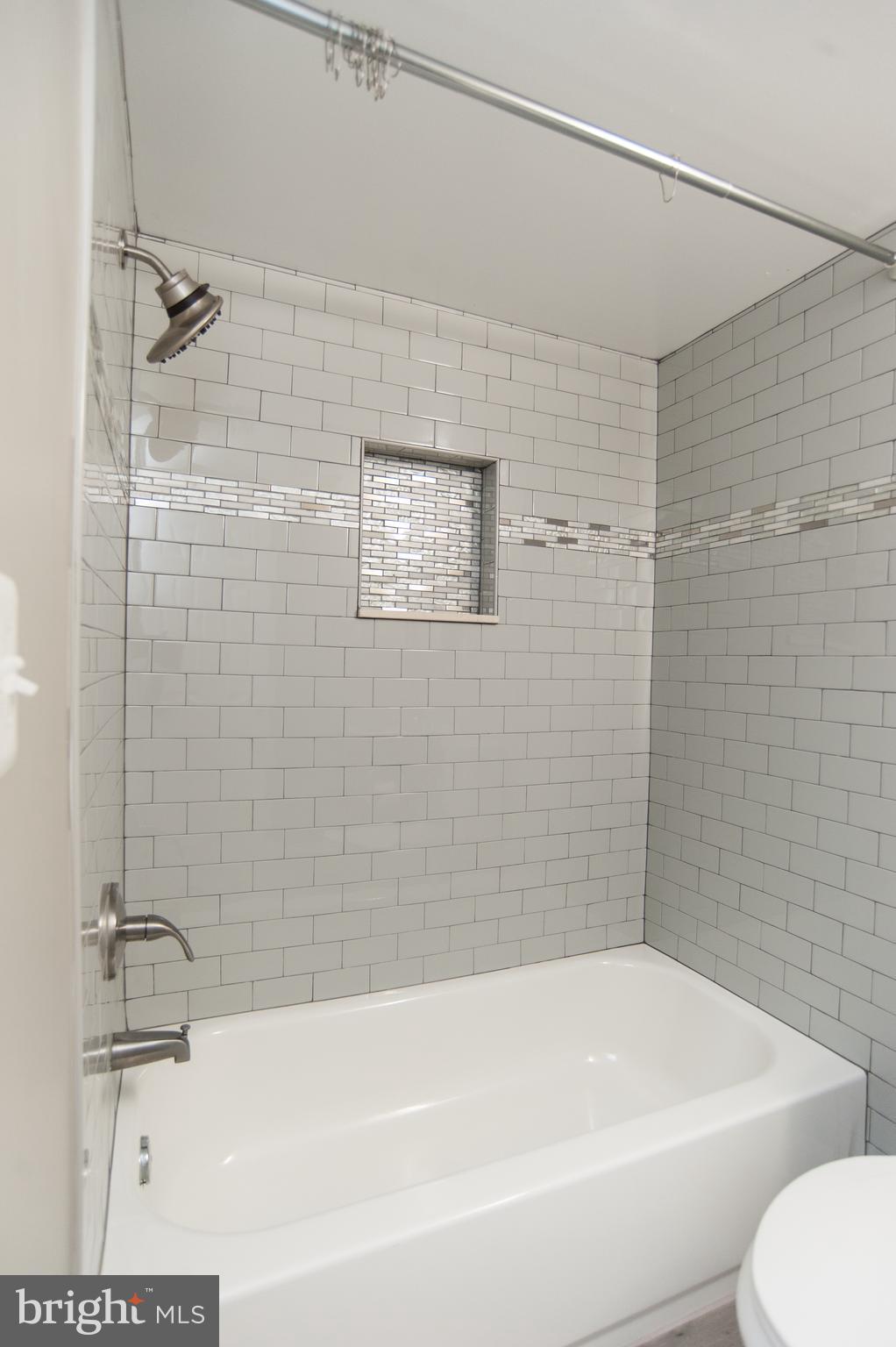 2022 4th Street Northeast, Unit B Washington, DC 20002 - Photo 11 of 16 a bathroom with a bathtub and a shower