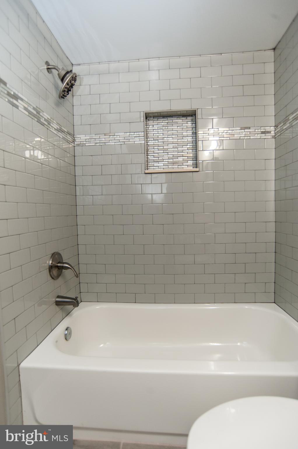 2022 4th Street Northeast, Unit B Washington, DC 20002 - Photo 12 of 16 a bathroom with a shower and a bathtub
