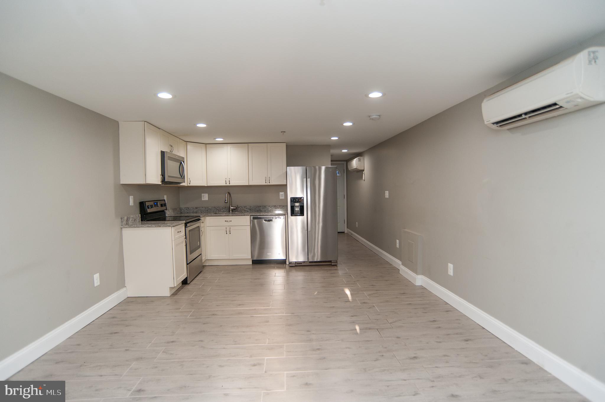 2022 4th Street Northeast, Unit B Washington, DC 20002 - Photo 16 of 16 a kitchen with stainless steel appliances granite countertop a refrigerator sink and white cabinets