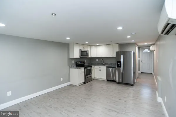a kitchen with stainless steel appliances granite countertop a refrigerator stove a sink and microwave