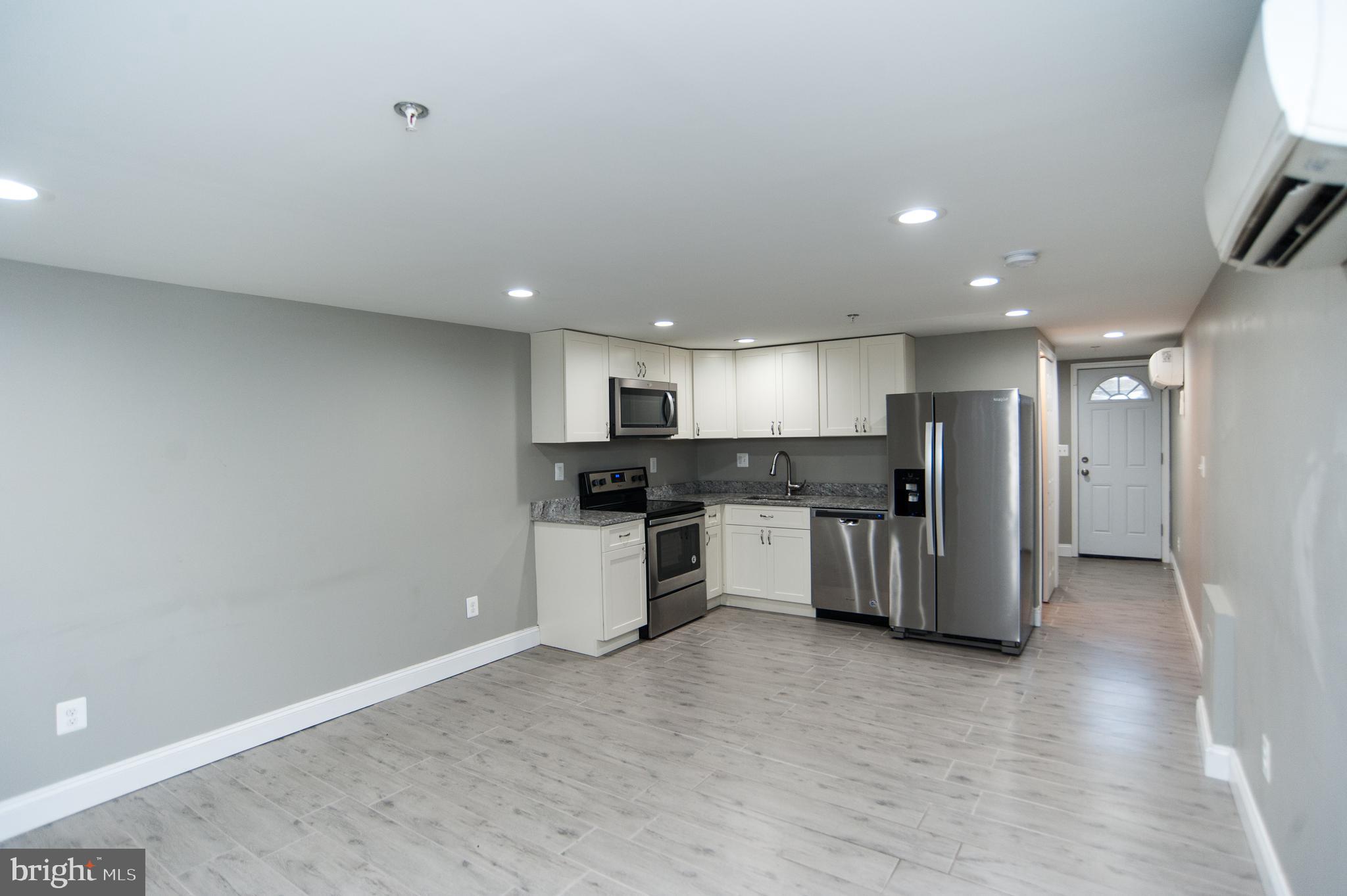 2022 4th Street Northeast, Unit B Washington, DC 20002 - Photo 3 of 16 a large kitchen with a refrigerator and a stove top oven