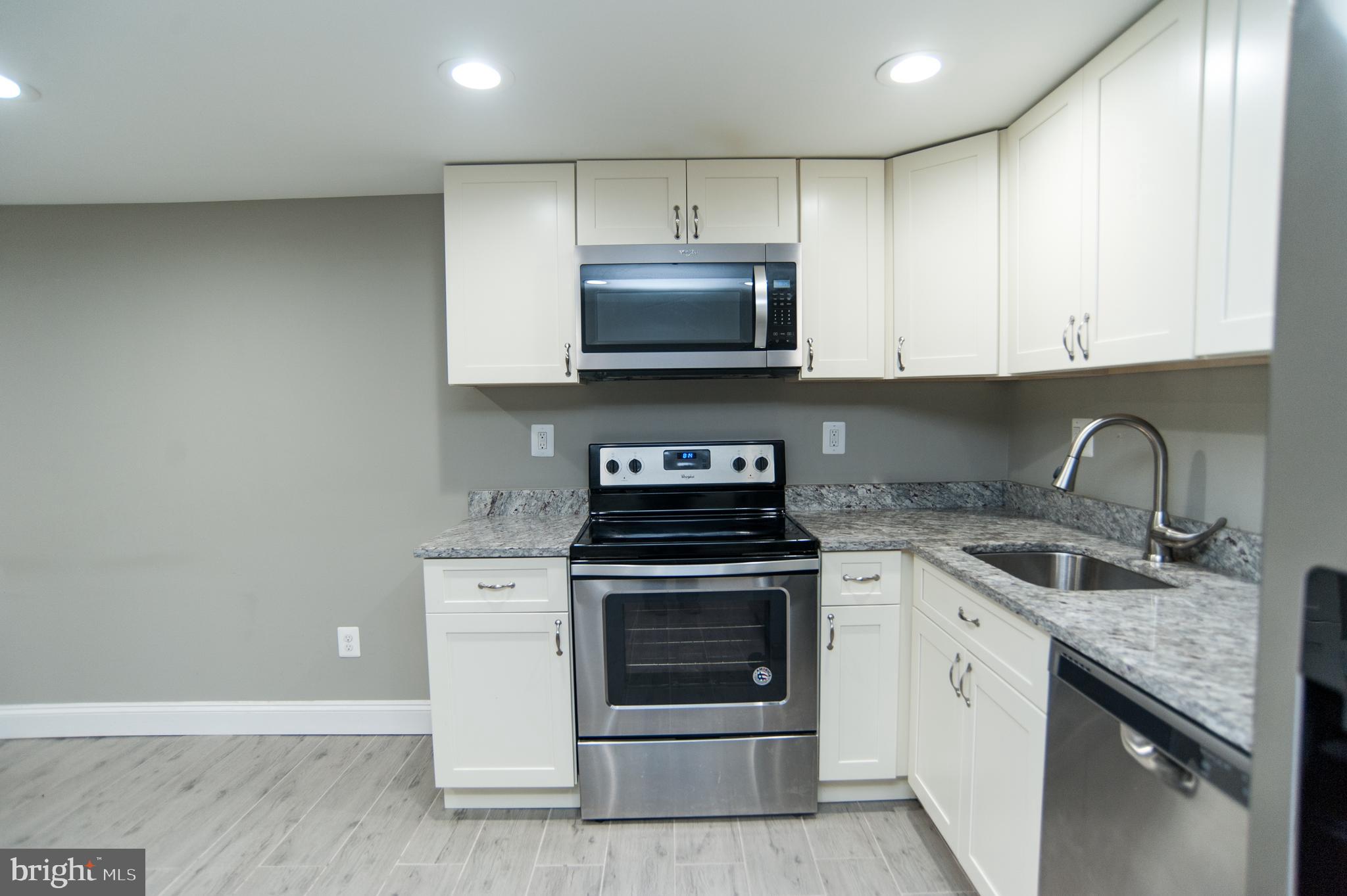 2022 4th Street Northeast, Unit B Washington, DC 20002 - Photo 5 of 16 a kitchen with granite countertop a stove and a sink