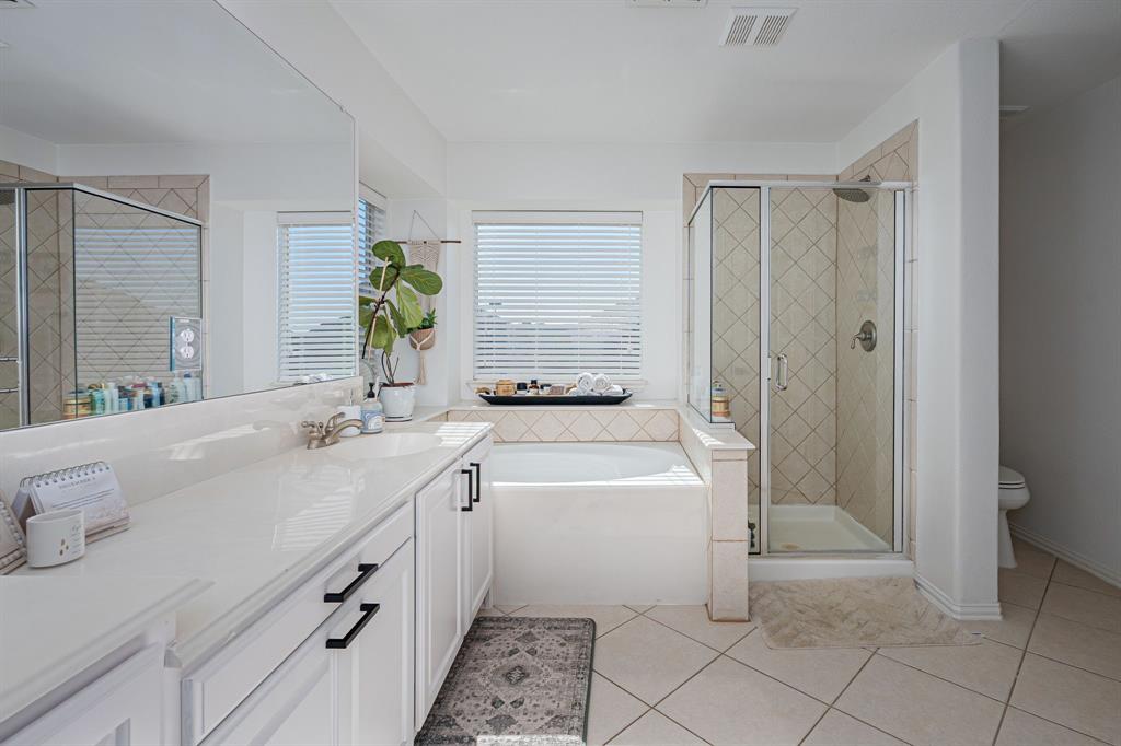 14521 Crystal Lake Drive Little Elm, TX 75068 - Photo 22 of 40 a bathroom with a granite countertop sink a toilet and shower