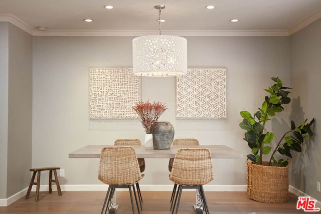 a dining room with furniture and a potted plant