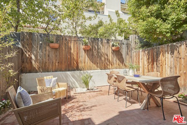 a view of a chairs and table in the patio