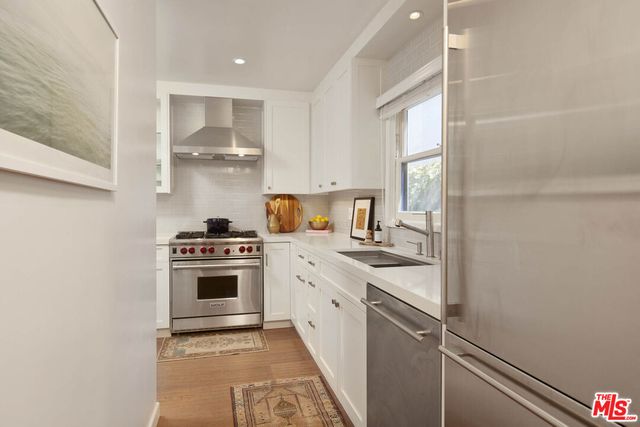a kitchen with a stove cabinets and a refrigerator