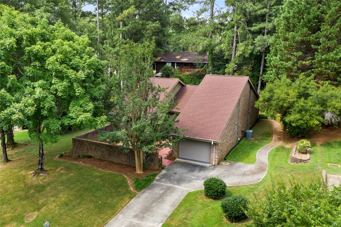 A verdant retreat, this home is nestled among established trees, offering privacy and natural beauty.