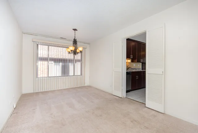an empty room with windows and cabinet