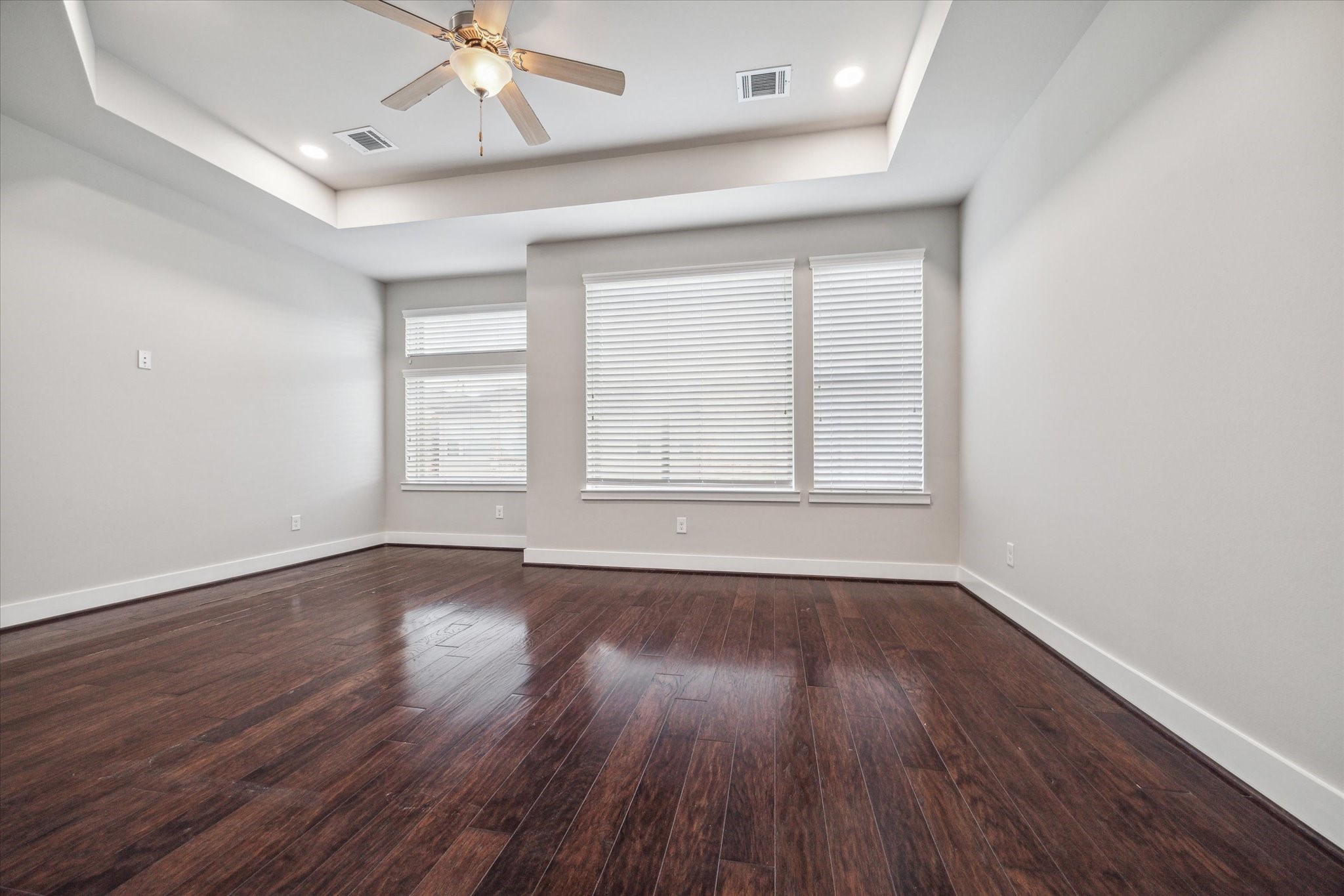 4508 Cornish Street, Unit A Houston, TX 77007 - Photo 11 of 22 The oversized Primary Retreat features hardwoods, a tray ceiling, a wall of windows including a nook which is a perfect space for a sitting area, makeup vanity or desk.