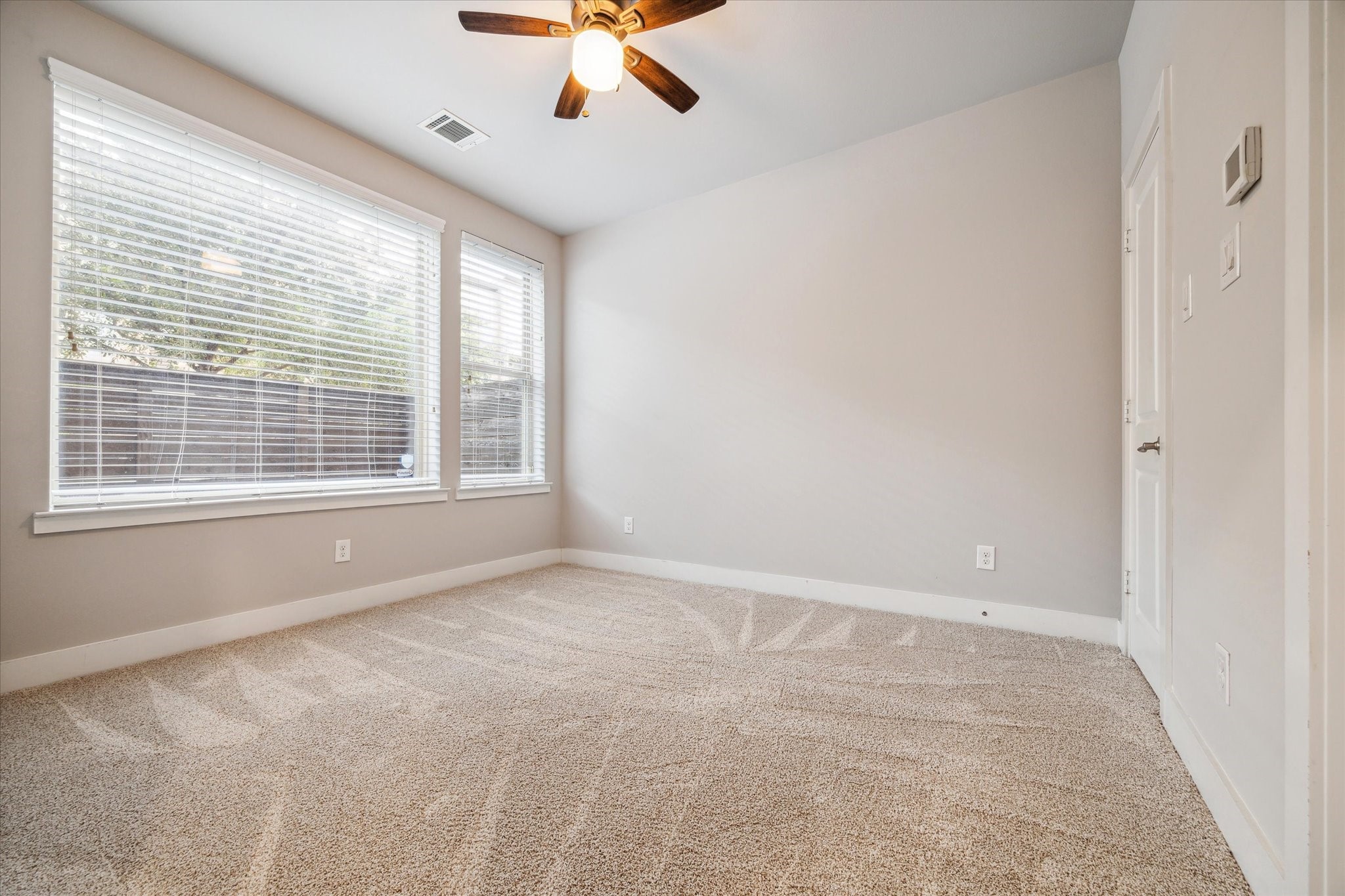 4508 Cornish Street, Unit A Houston, TX 77007 - Photo 18 of 22 First floor bedroom features a wall of windows that overlook the front patio and also features an en suite bath.