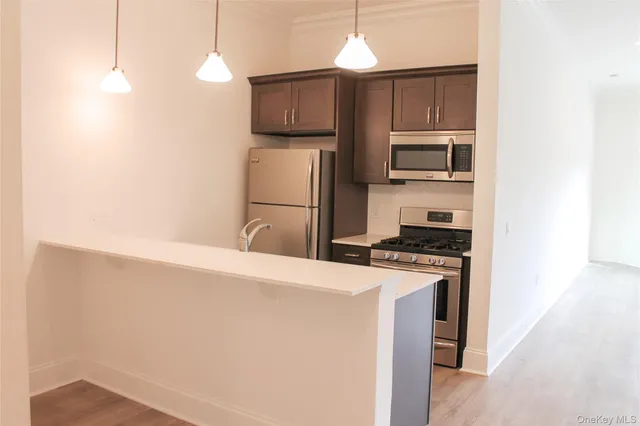 a kitchen with a refrigerator stove and microwave