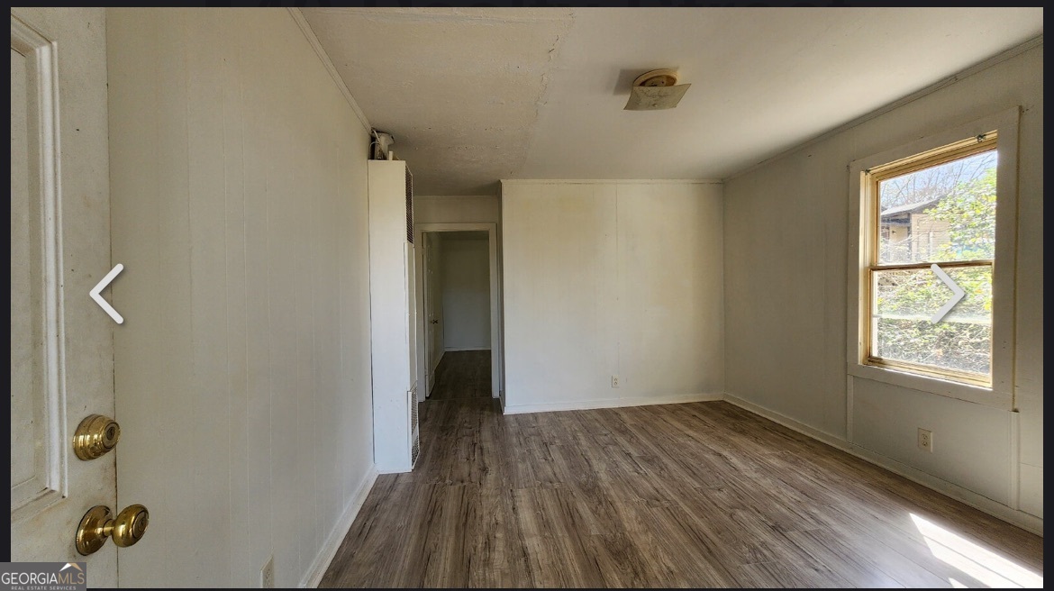 135 Alabama Street Griffin, GA 30223 - Photo 3 of 5 a view of hallway with a window and wooden floor
