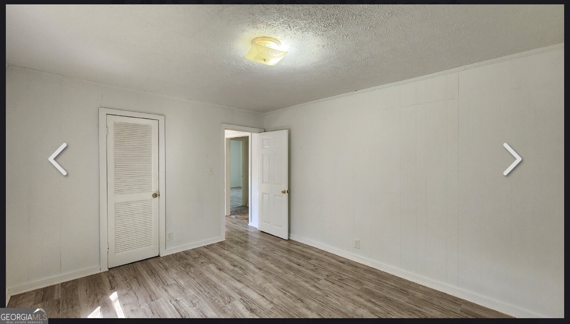 135 Alabama Street Griffin, GA 30223 - Photo 5 of 5 a view of empty room with wooden floor and fan