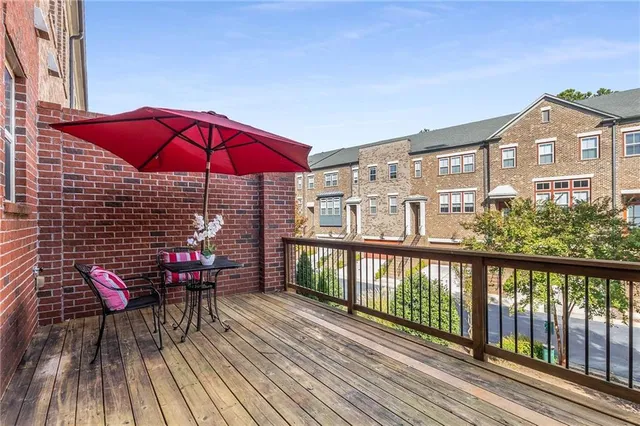 an outdoor sitting area with red umbrella