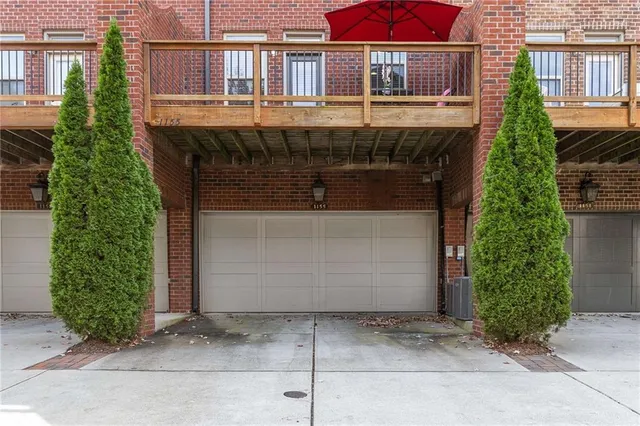 an empty room with windows and chandelier fan