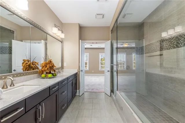 a bathroom with a granite countertop sink mirror and double