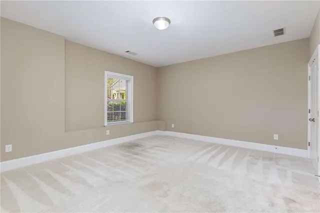 an empty room with closet and mirror