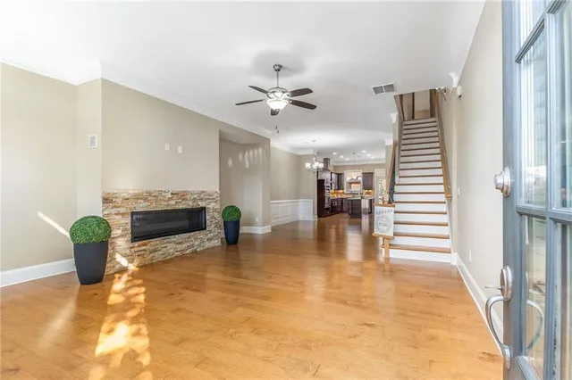 a kitchen with stainless steel appliances kitchen island granite countertop a sink stove and refrigerator