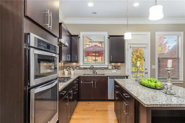 a kitchen with a sink stove top oven and cabinets