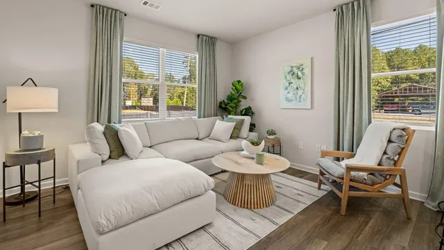 a living room with furniture and a large window