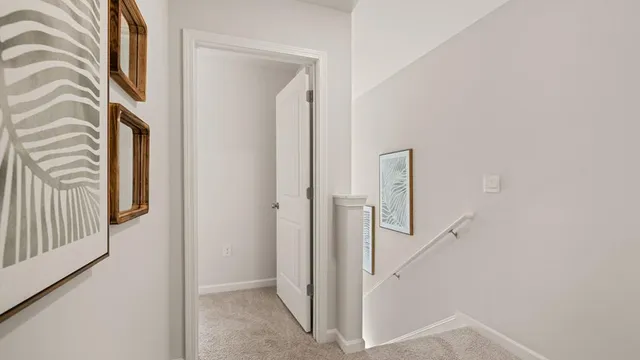 a view of a hallway with entryway and wooden floor