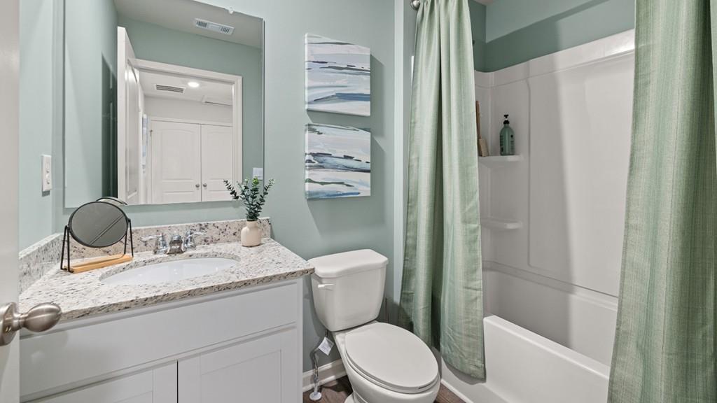 4 Sweetspire Drive Northwest Rome, GA 30165 - Photo 37 of 47 a bathroom with a granite countertop toilet sink and mirror