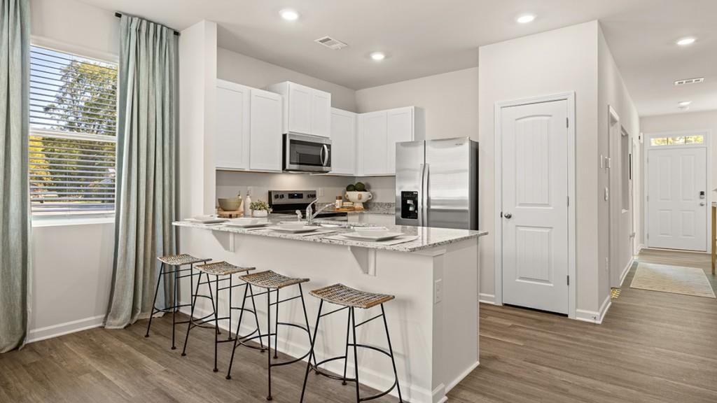 4 Sweetspire Drive Northwest Rome, GA 30165 - Photo 6 of 47 a kitchen with stainless steel appliances granite countertop a refrigerator a stove a sink and white cabinets with wooden floor
