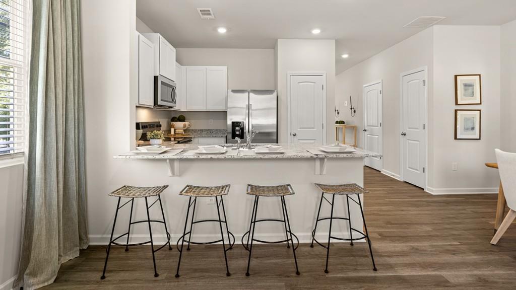 4 Sweetspire Drive Northwest Rome, GA 30165 - Photo 7 of 47 a kitchen with stainless steel appliances kitchen island granite countertop a table chairs sink and cabinets