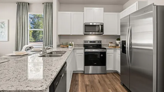 a kitchen with a sink stove and refrigerator