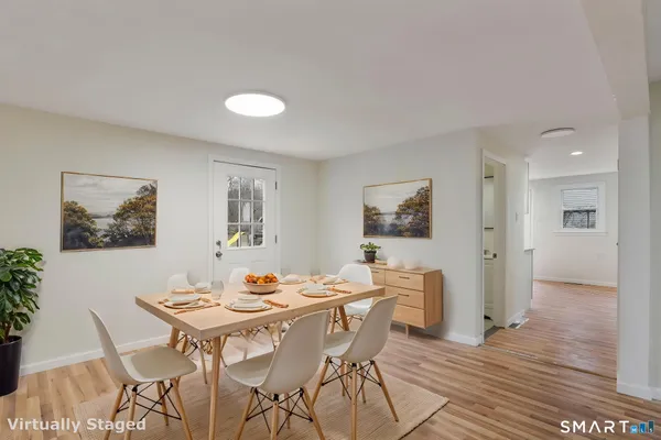 a view of a dining room with furniture and wooden floor