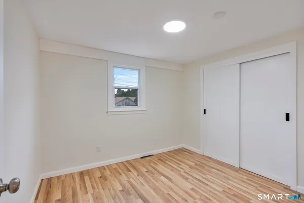 a view of room with wooden floor and fan