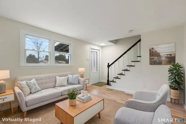 a living room with furniture and a potted plant