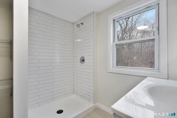 a bathroom with a tub and a shower