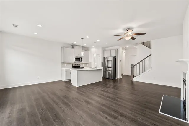 a view of kitchen with sink and refrigerator