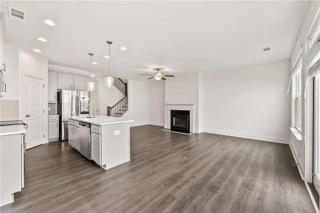 a view of kitchen with sink and refrigerator