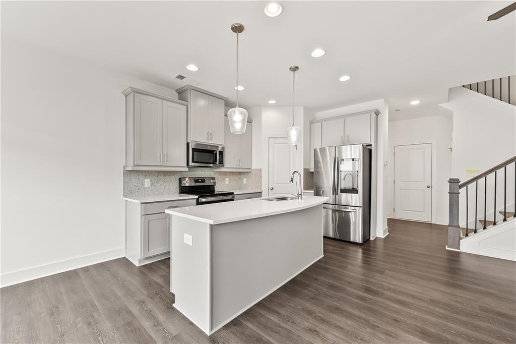 98 Auburn Valley Way Auburn, GA 30011 - Photo 17 of 47 a kitchen with stainless steel appliances a refrigerator sink and microwave